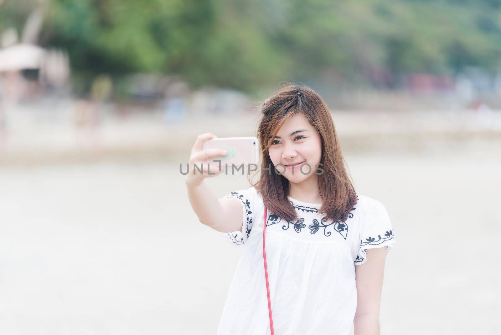 asian girl selfie on the beach by Wmpix