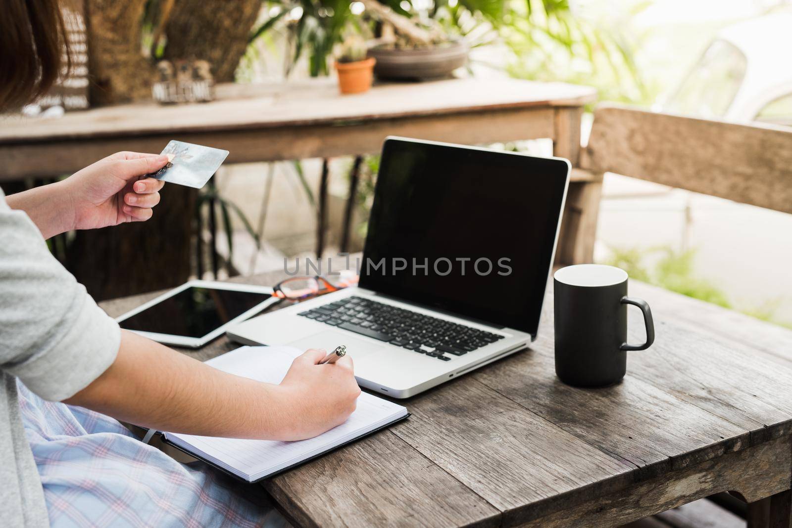 Work concept. Clipboard in man hands. Laptop and cup of tea on wooden table by Wmpix