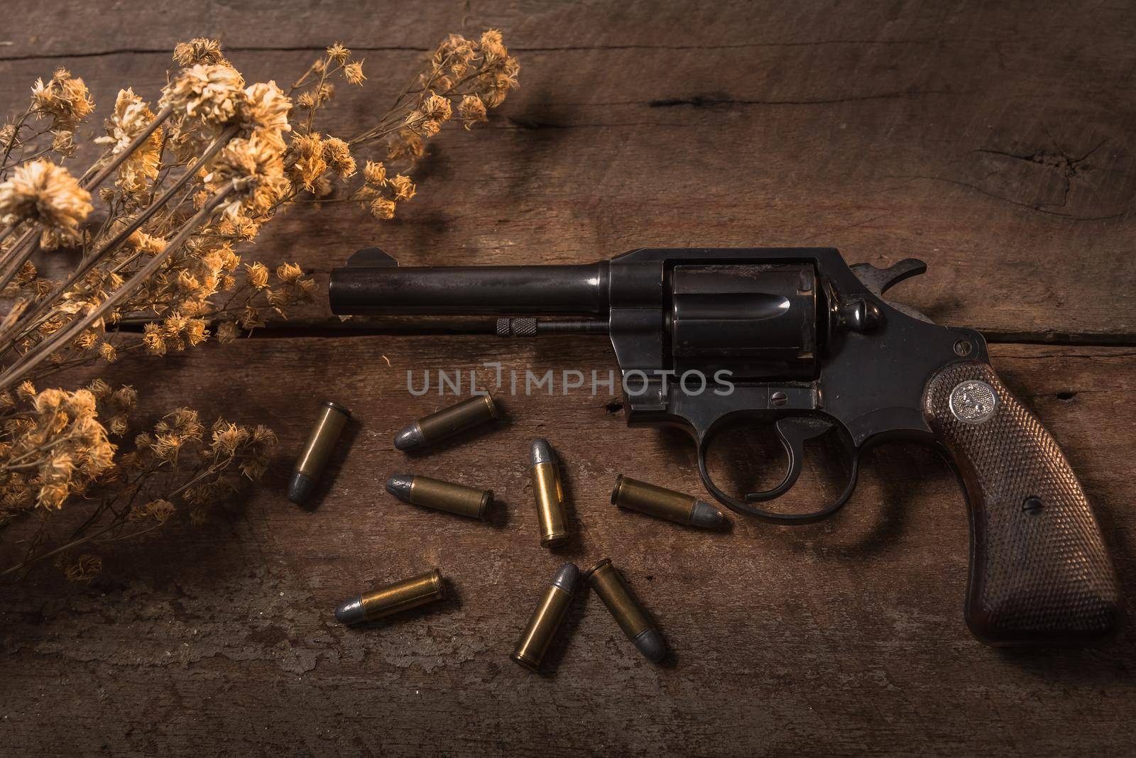 handgun bullets on wood table by Wmpix