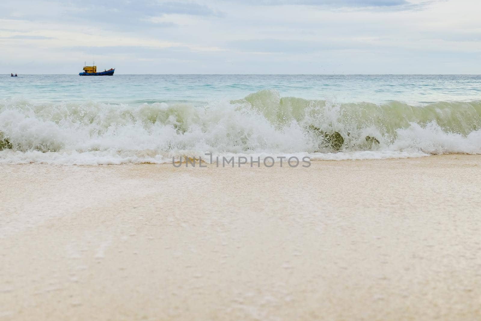 Waves crashing on the beach by Wmpix