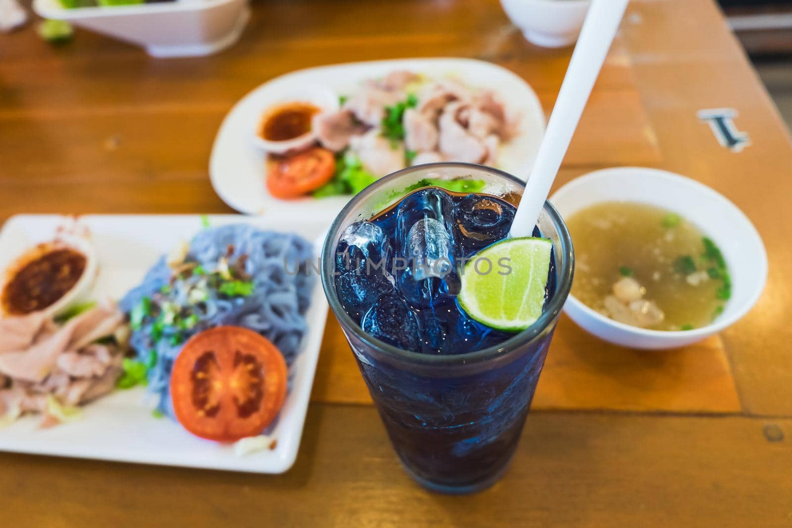 purple blue color herbal drink on meal table by Wmpix