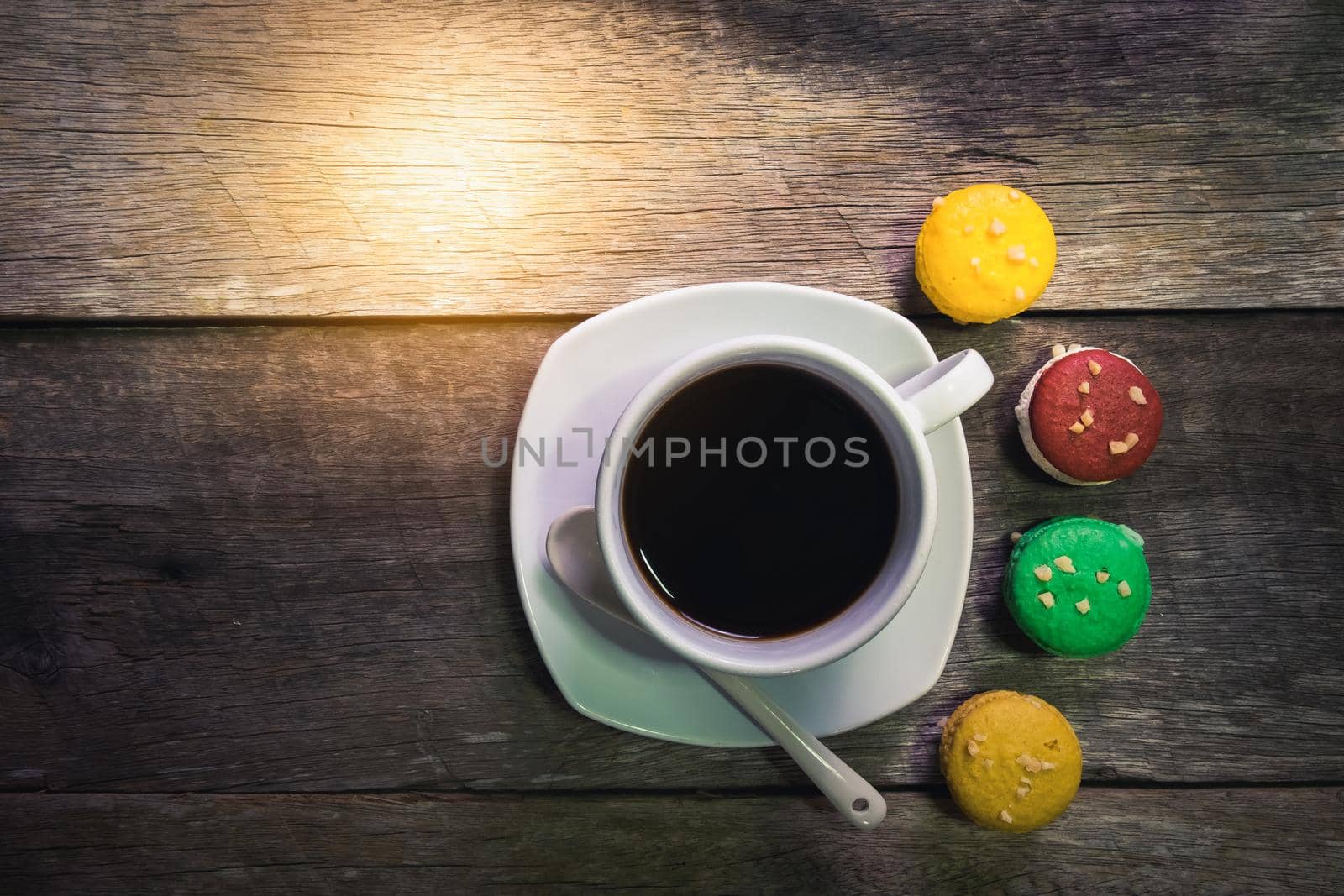 macaroon and cup of coffee on wood table,Vintage color by Wmpix