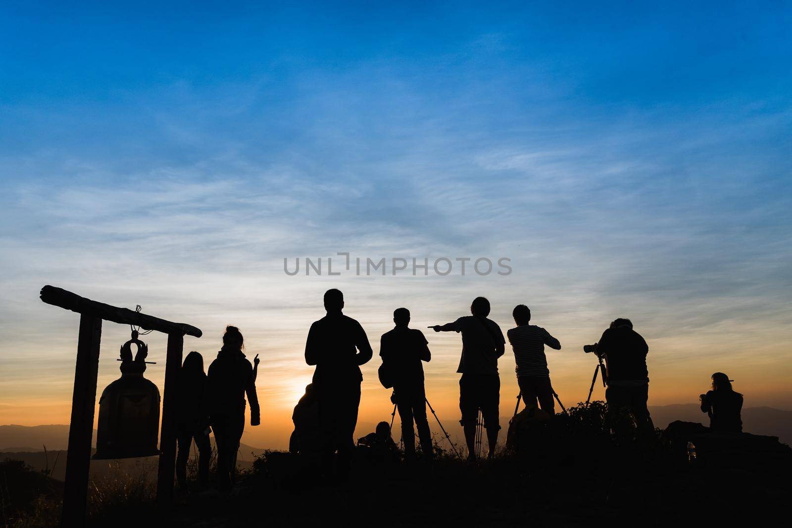 Photographers Silhouettes On Cliff Against Colorful Twilight Sky