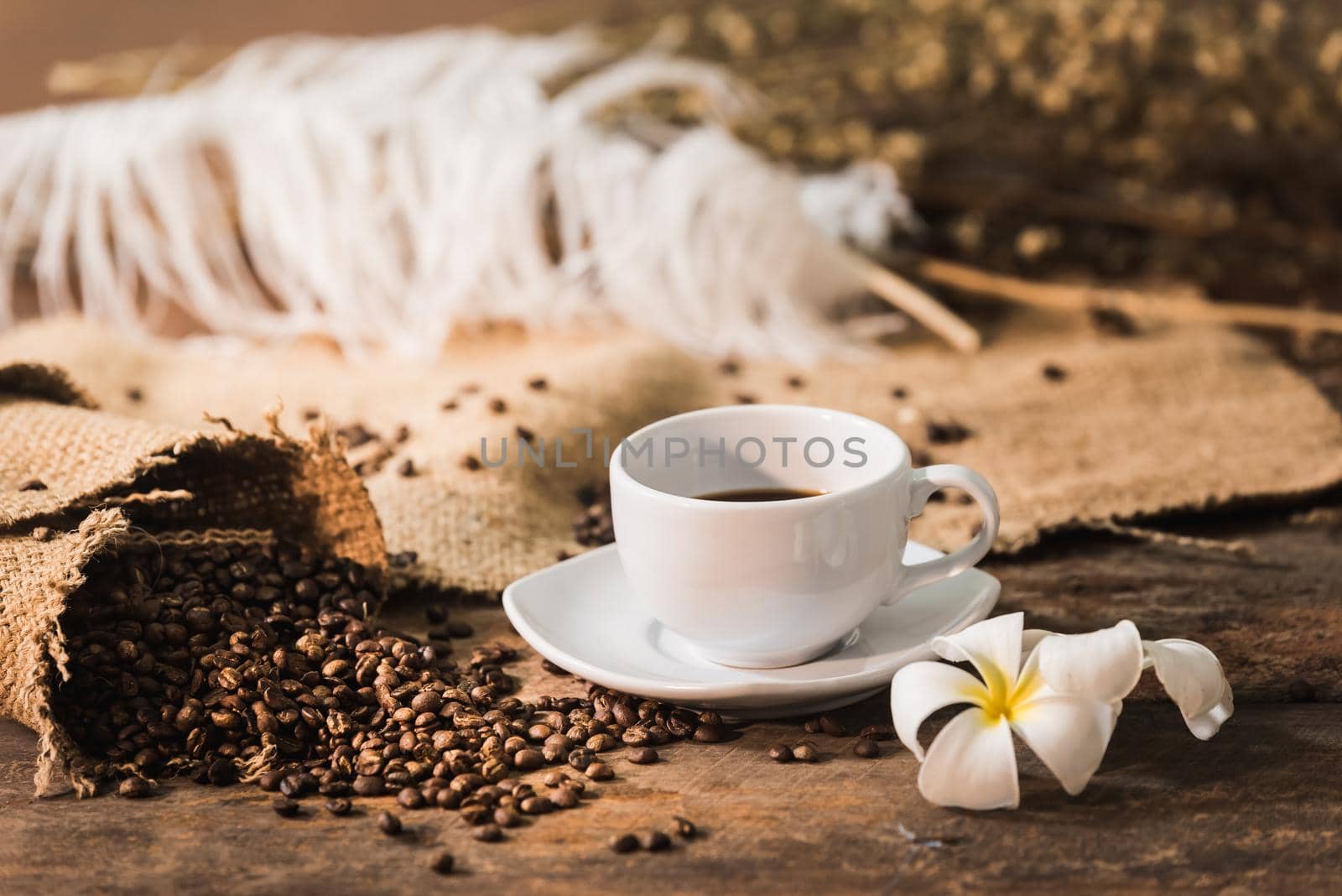 Coffee cup and coffee beans on wood table