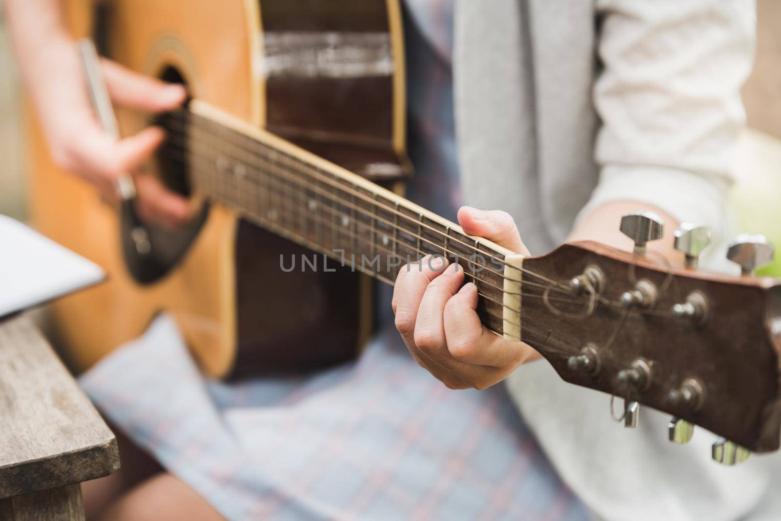 Girl playing Acoustic Guitar Closeup  by Wmpix