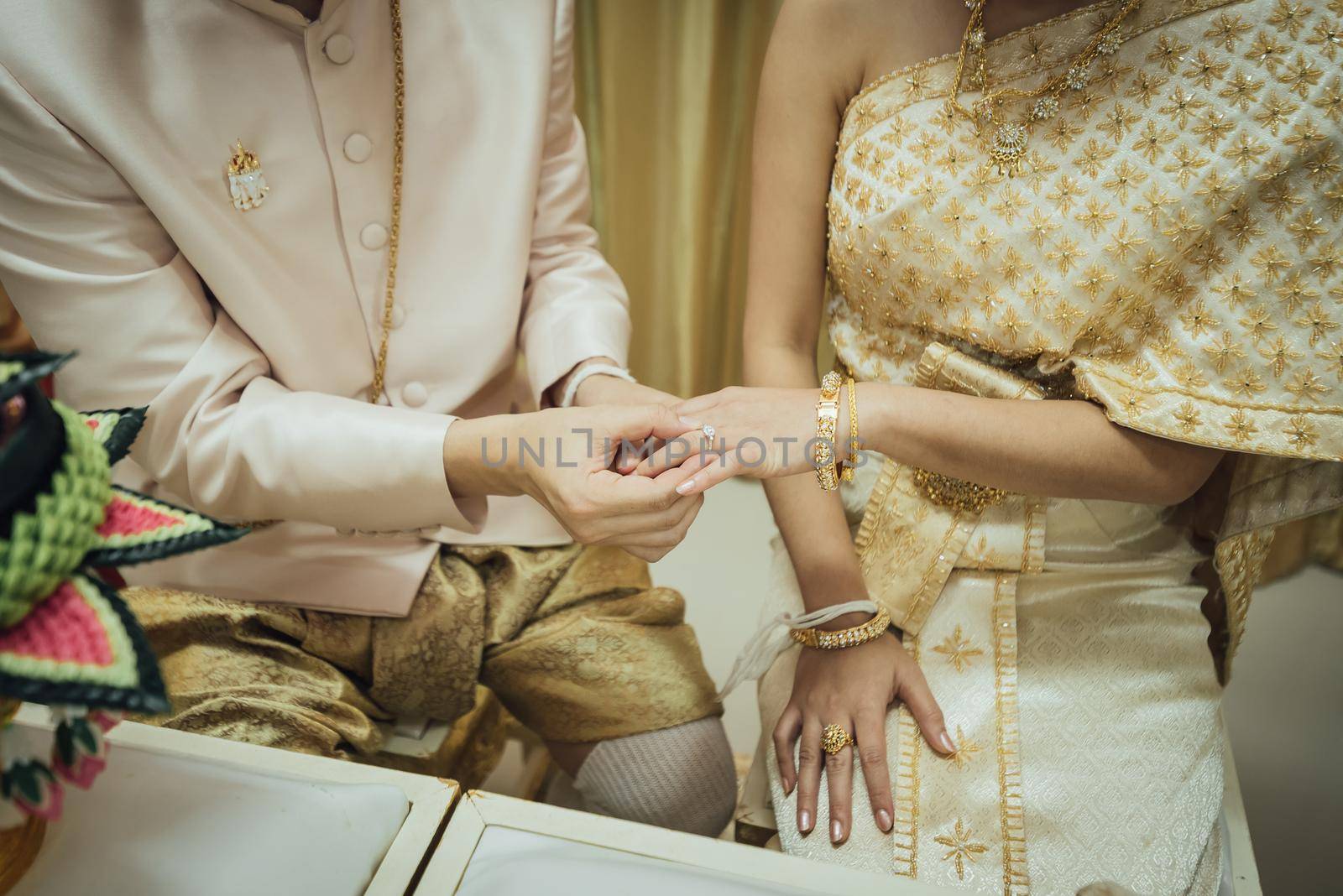 thai wedding, putting the wedding ring by Wmpix