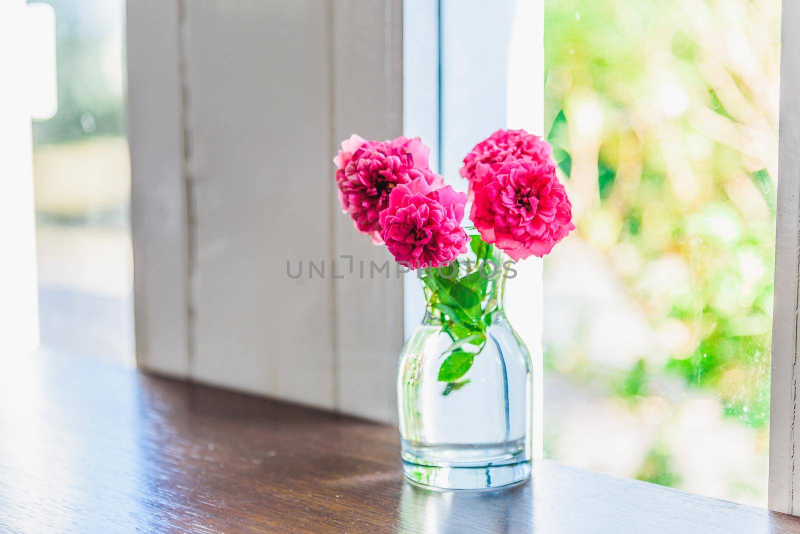 Bouquet of pink flowers on a windowsill