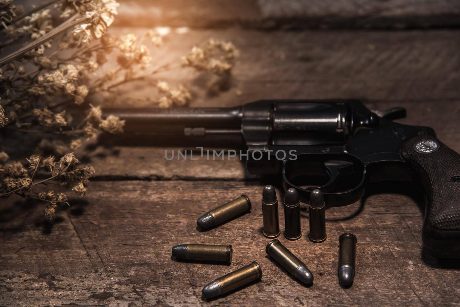 handgun bullets on wood table by Wmpix