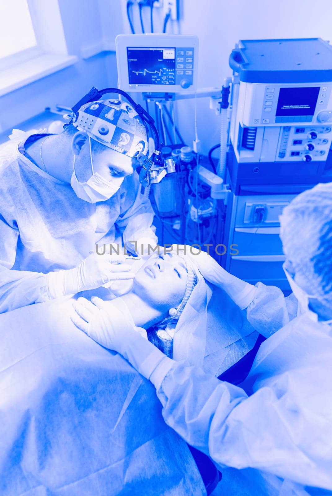 Man surgeon at work in operating room.