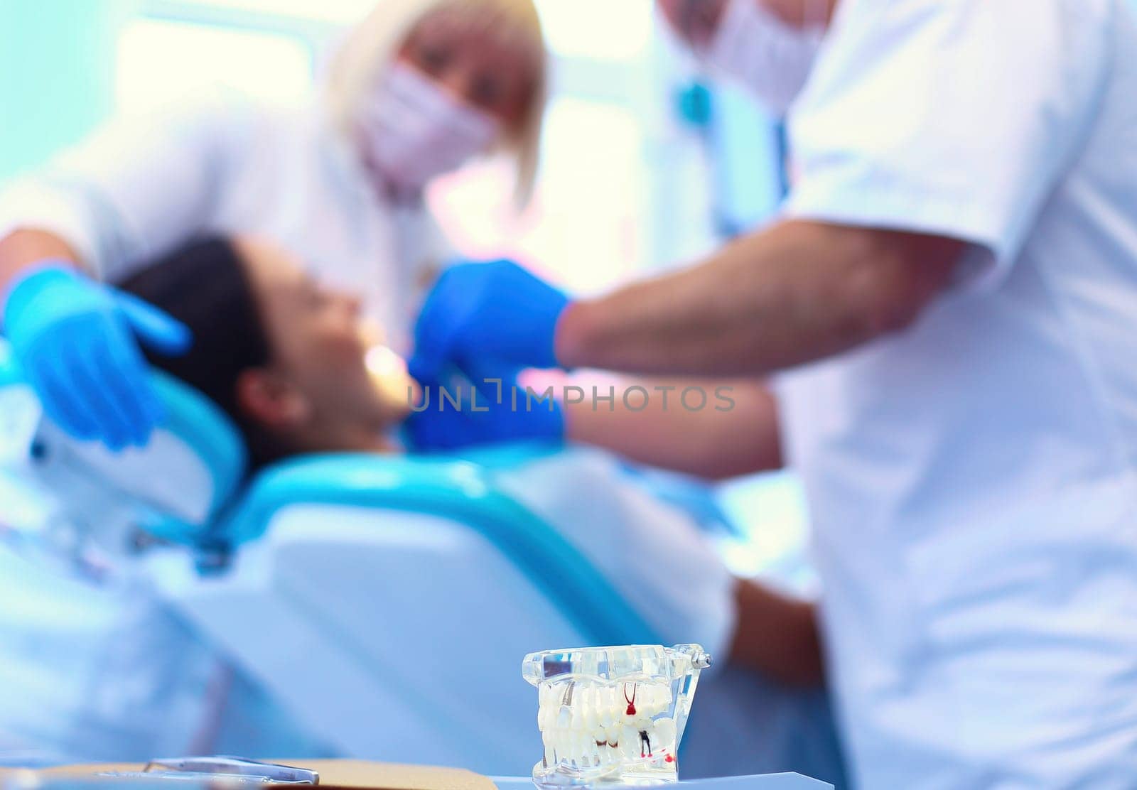 Dentist man with patient woman in clinic by lenets