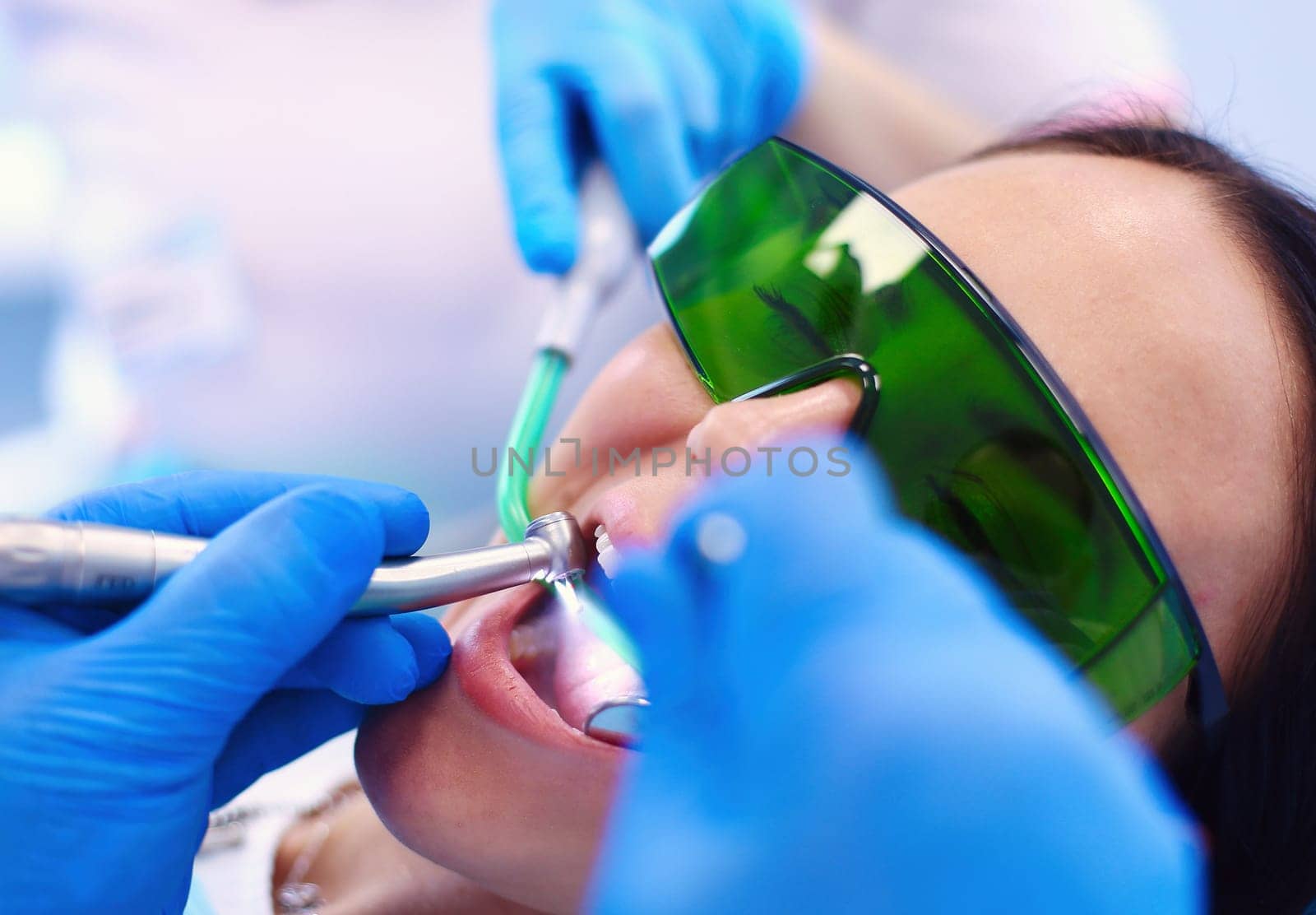 Dental team and patient at dentist's surgery.