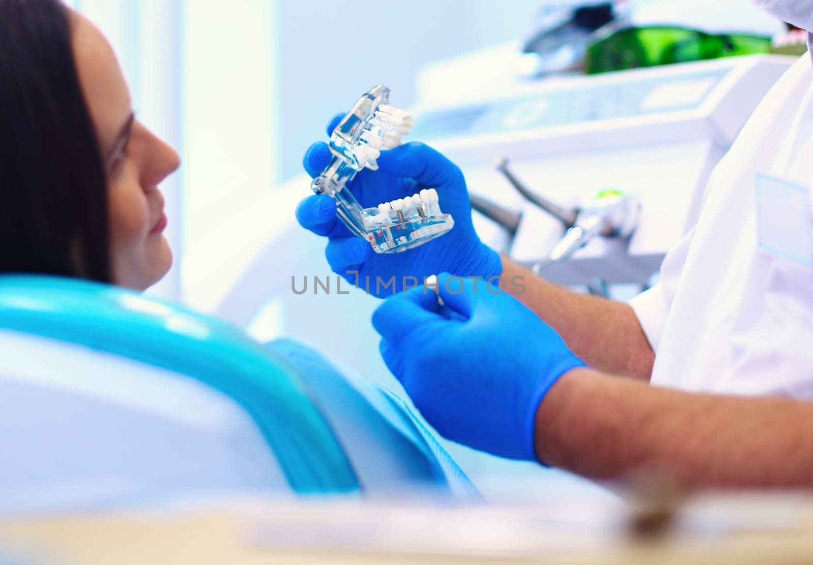 Beautiful senior woman at dentist having dental treatment at dentist's office.