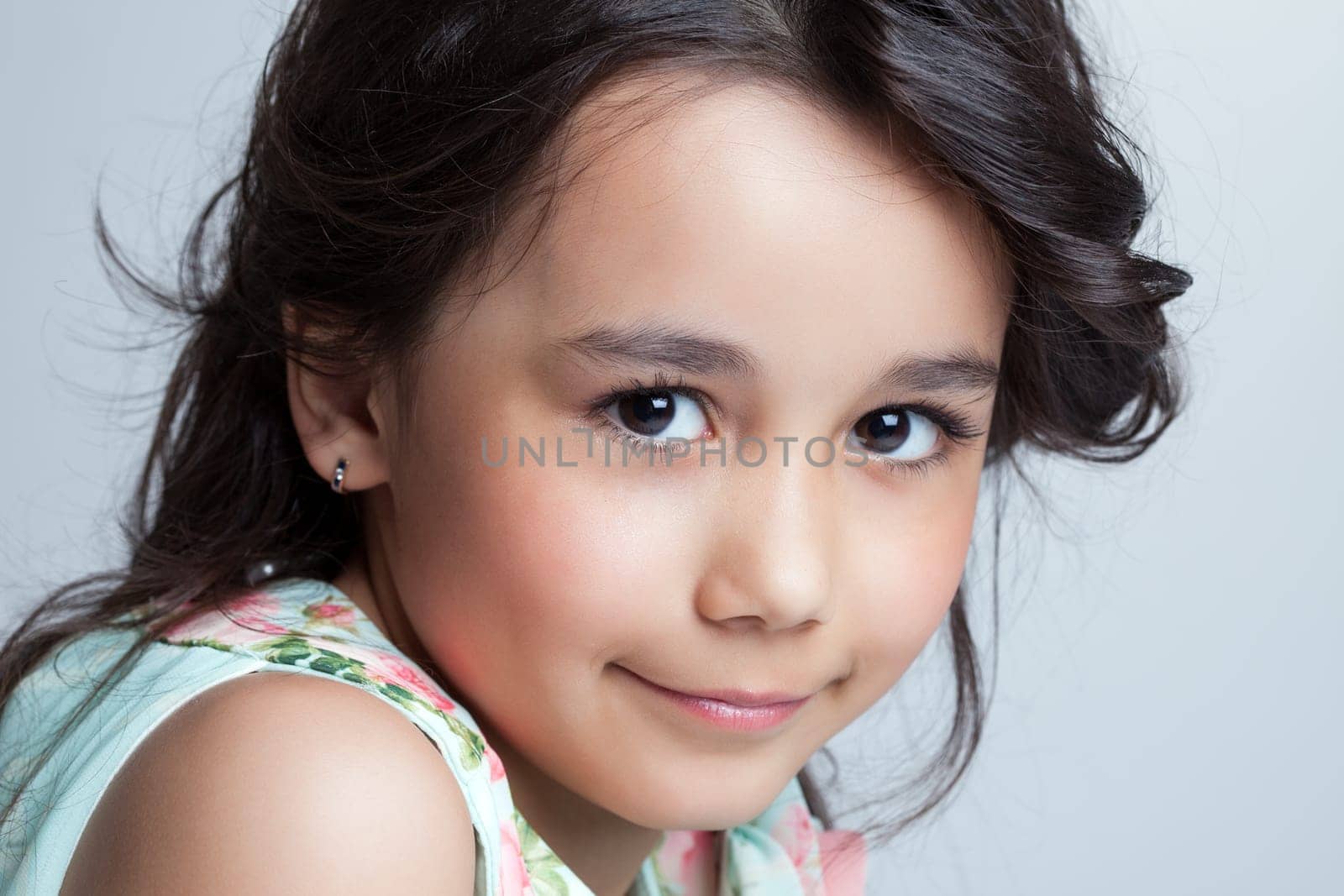 Portrait of smiling brown-eyed girl posing at camera
