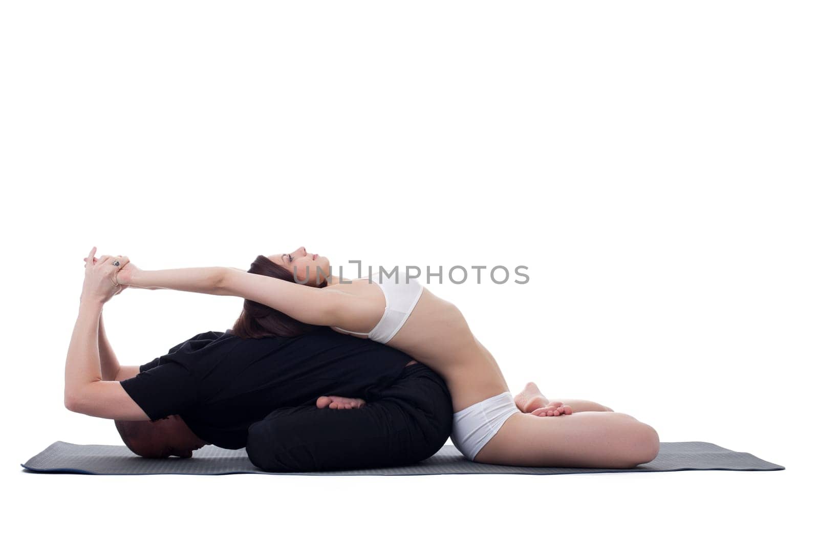 Healthy couple doing yoga and meditating by rivertime