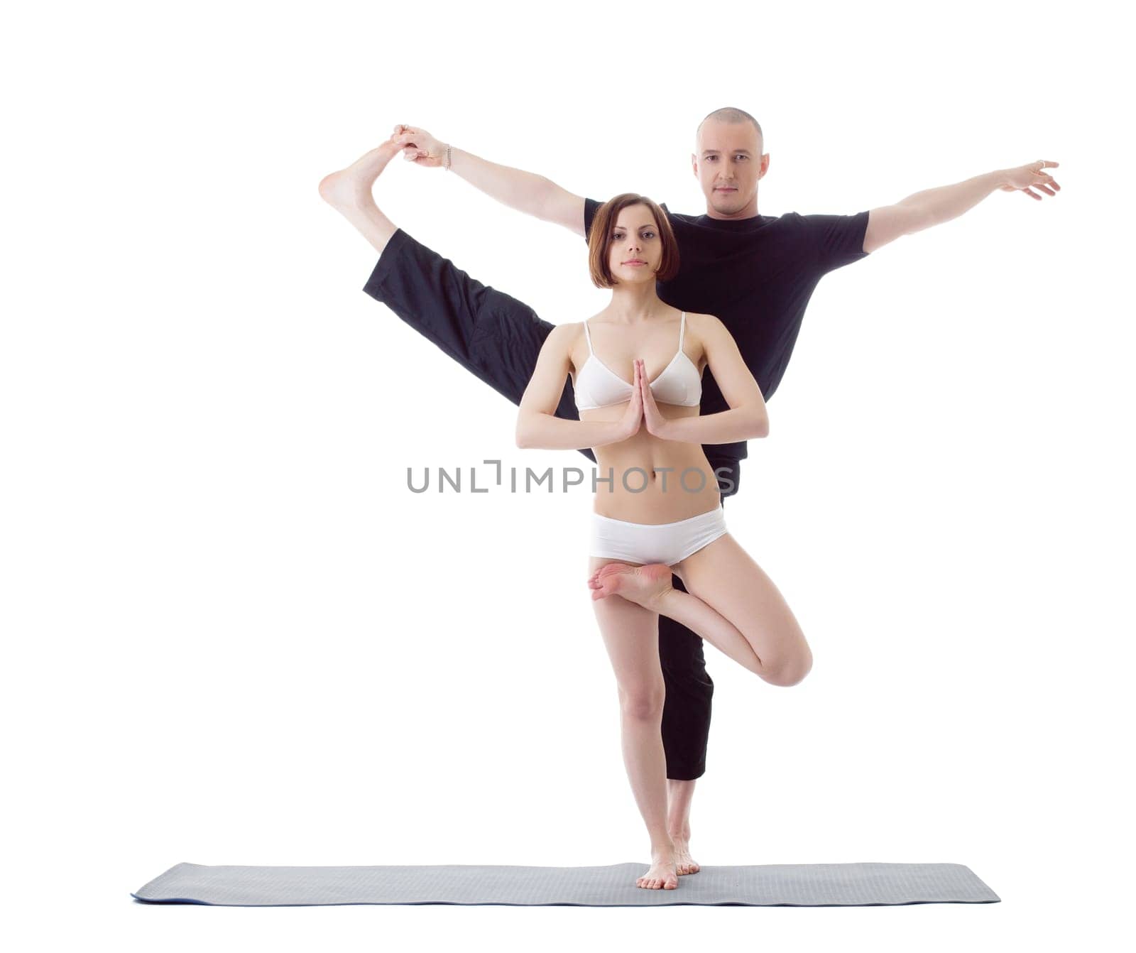 Couple of attractive Europeans practicing yoga at camera