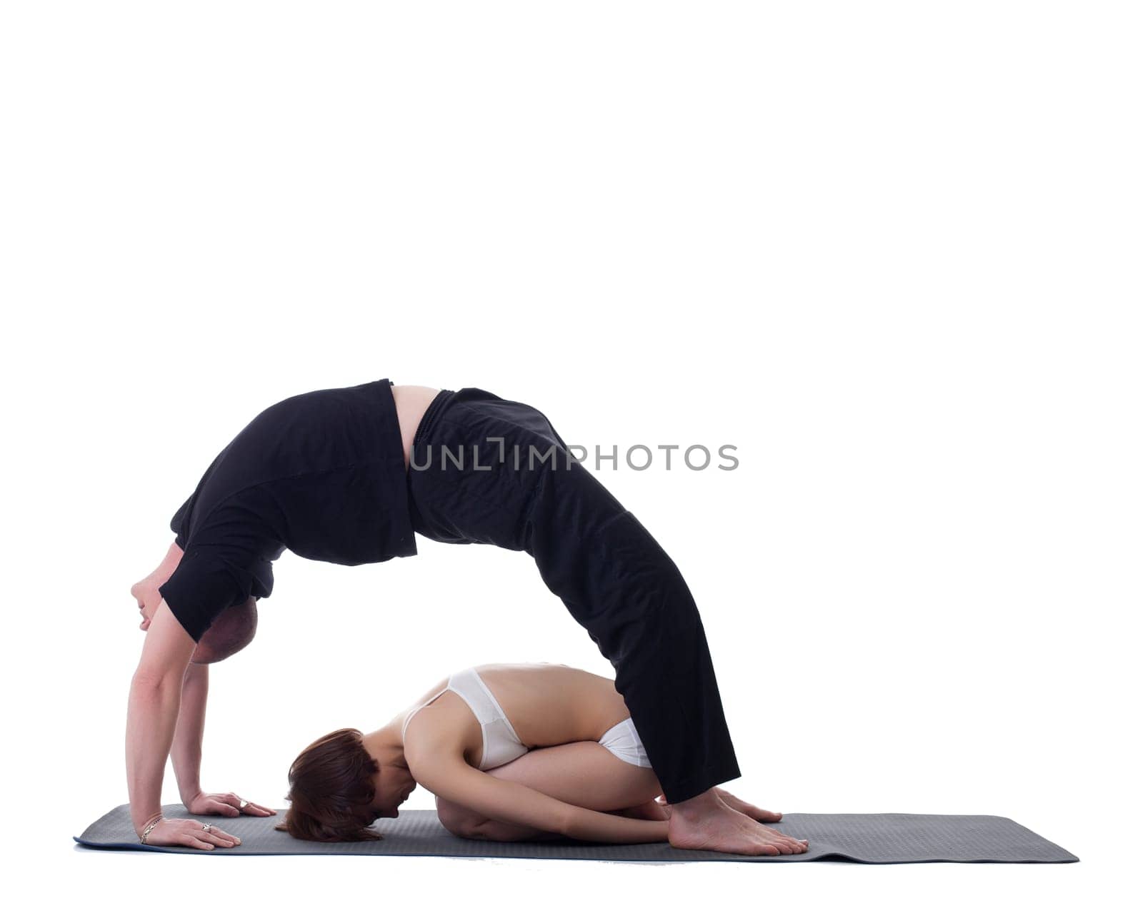 Image of flexible trainers practicing yoga by rivertime