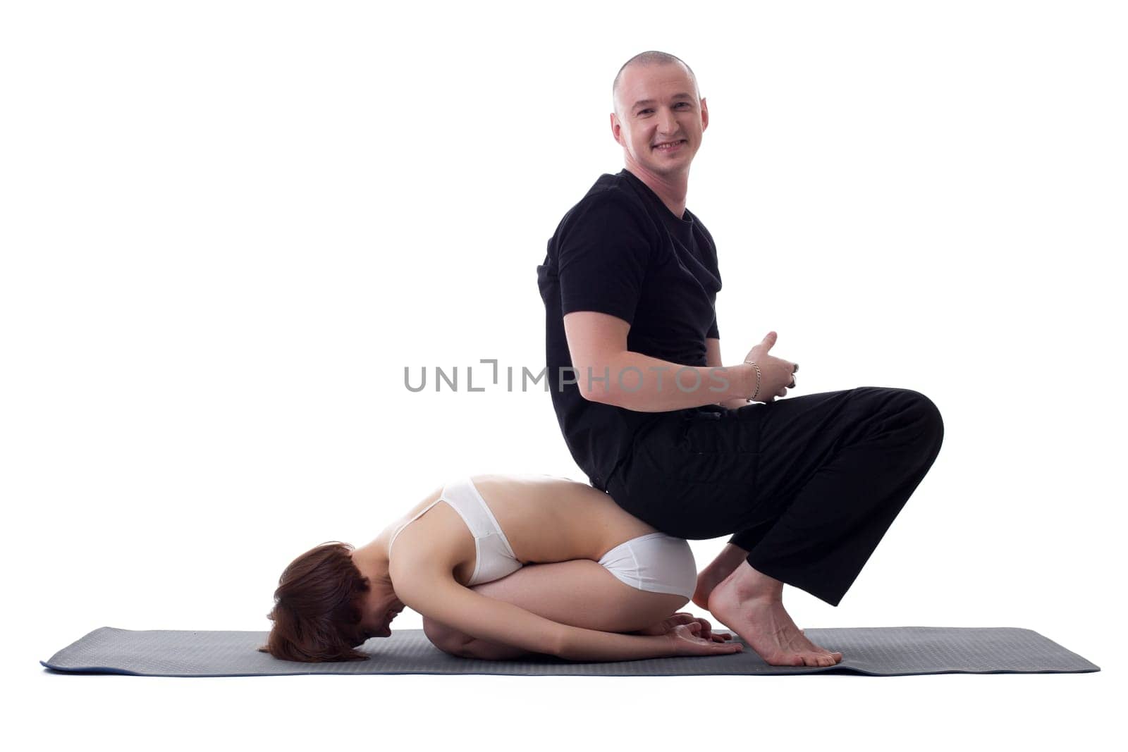 Studio shot of cheerful yogis posing at camera