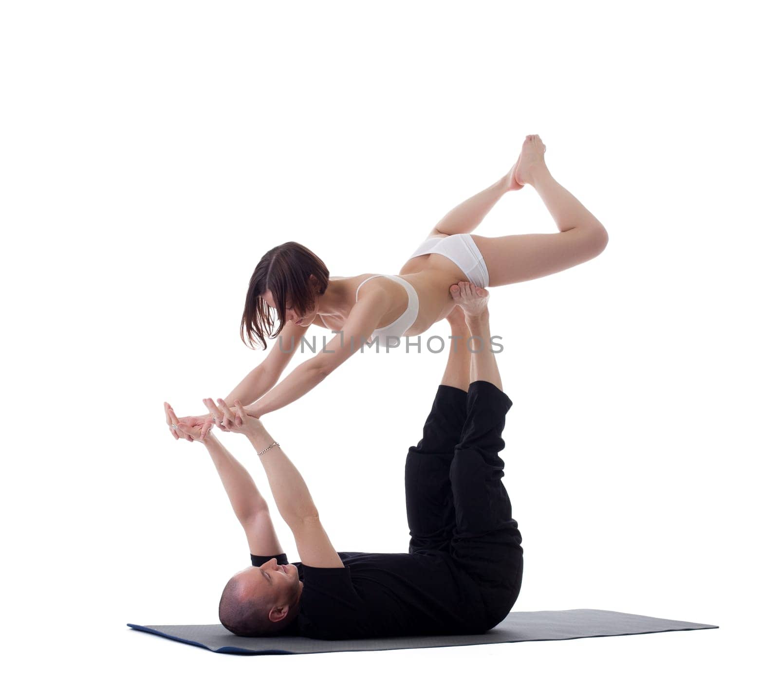 Pair of healthy yoga instructors practising in studio