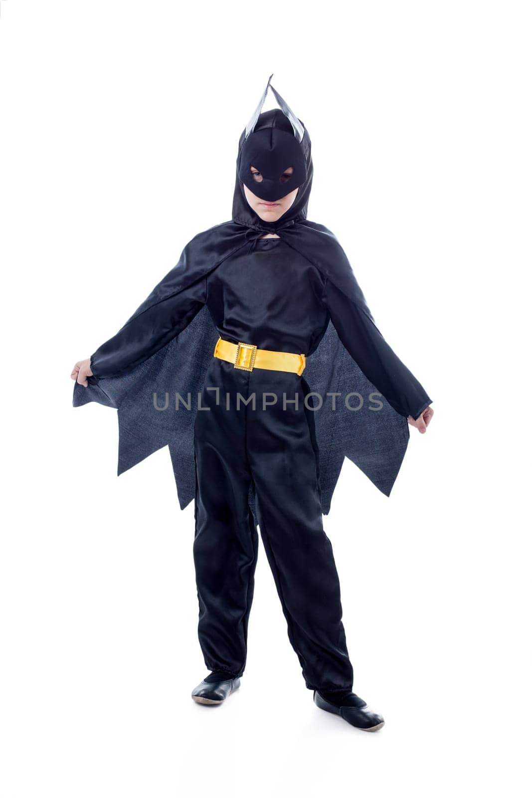 Studio shot of cute boy dressed as Batman, isolated on white