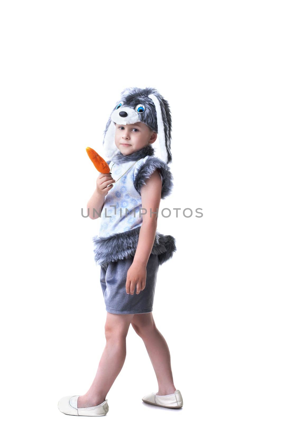 Image of cute boy in rabbit costume with carrot, isolated on white