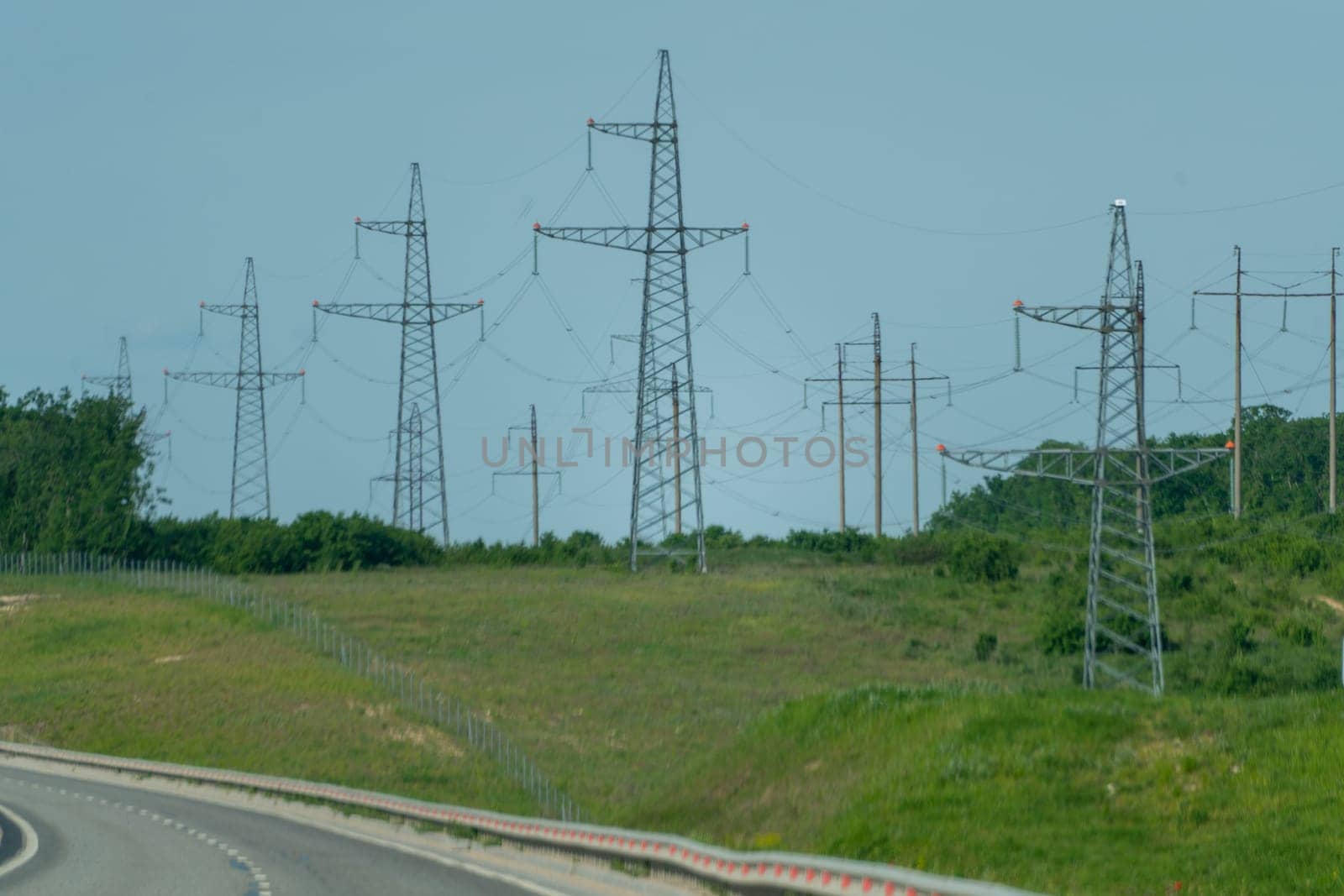 High voltage towers with sky background. Power line support with wires for electricity transmission. High voltage grid tower with wire cable at distribution station. Energy industry, energy saving.