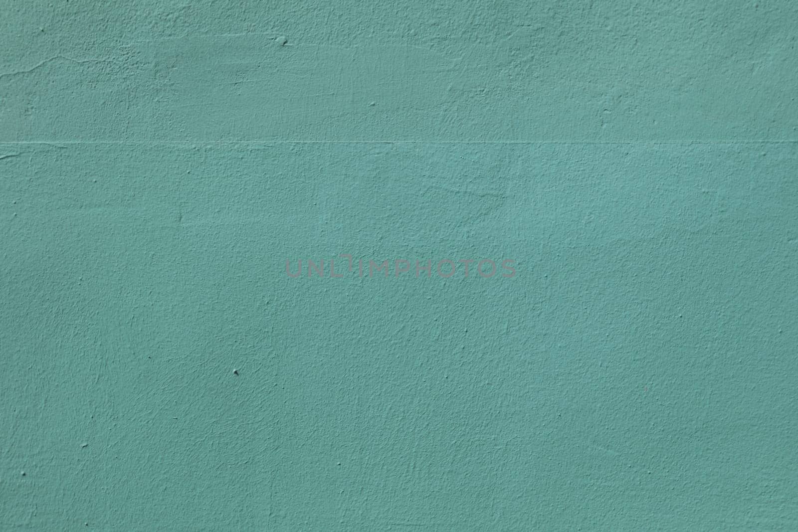 The surface of an old worn wall in blue and green. Background for a design with copy space.