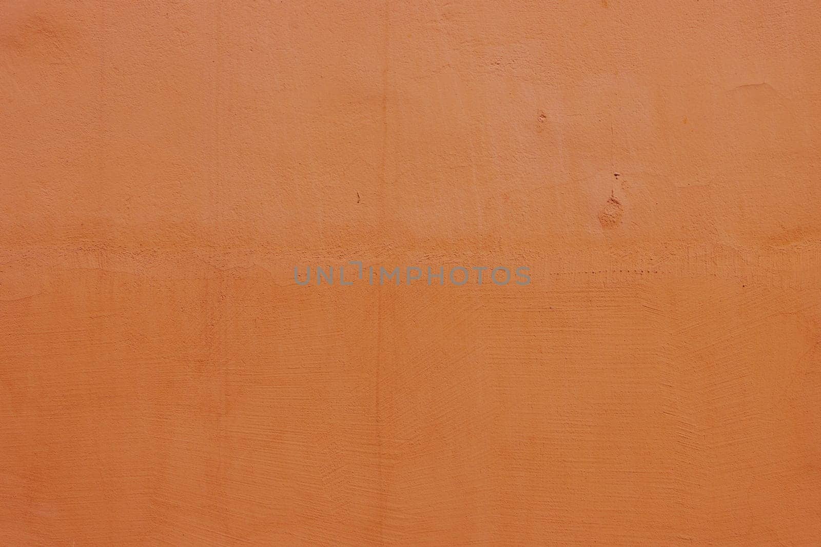 Texture for design with copy space. Concrete wall with orange plaster. Decorative wall surface .