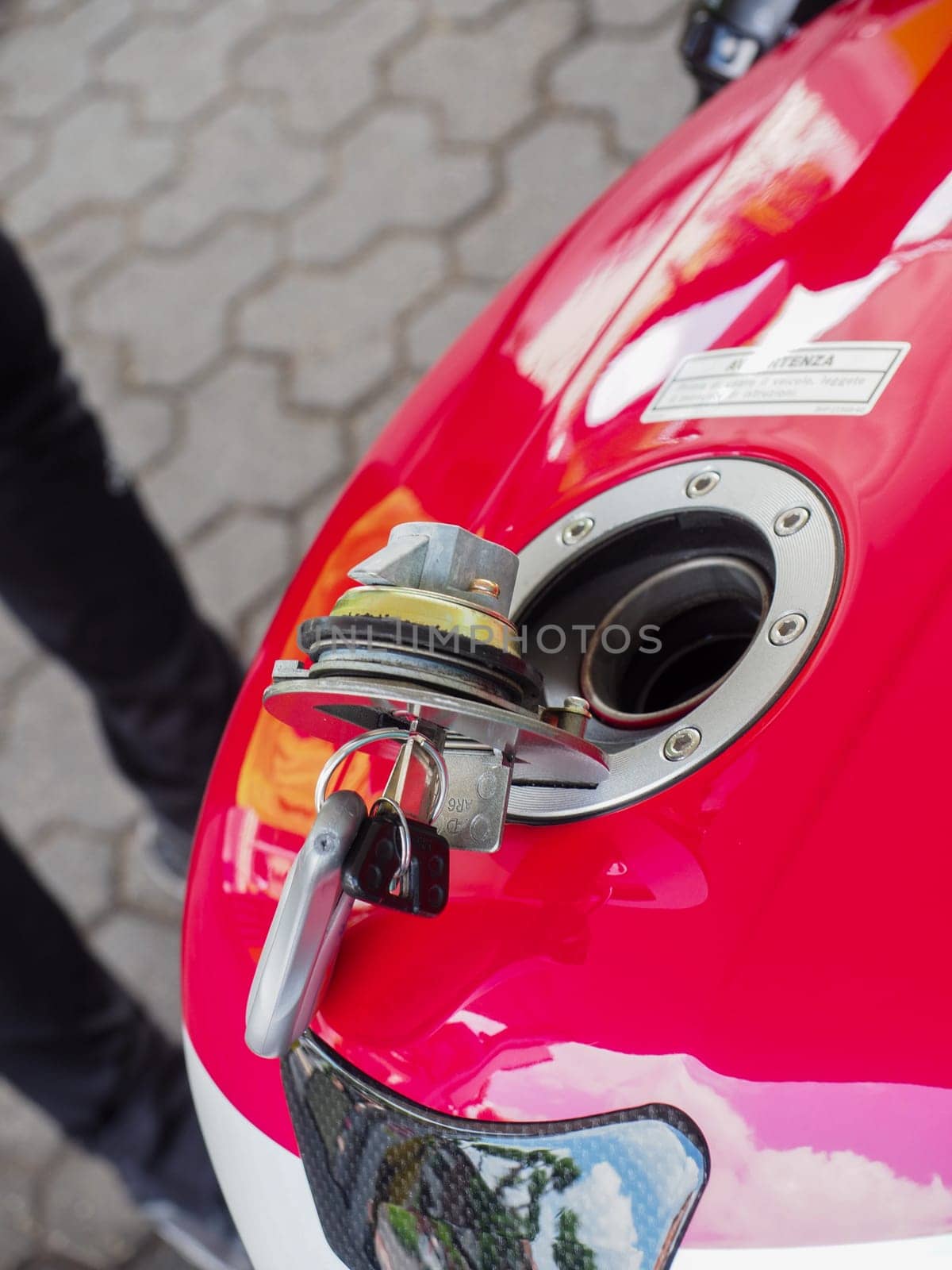 Cremona, Italy - July 3 2023 Customer self service refilling motorbikes at eni gas station