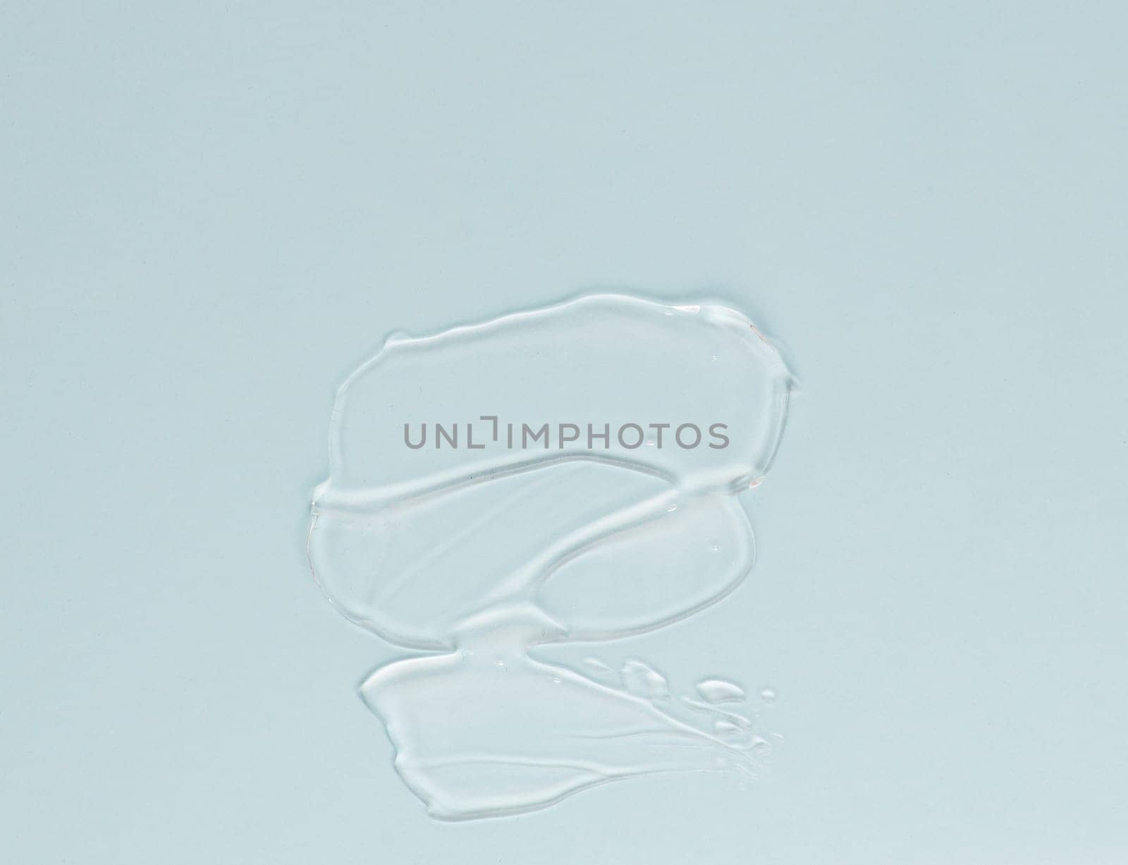 Smear of transparent cream for face and body on a blue background by A_Karim