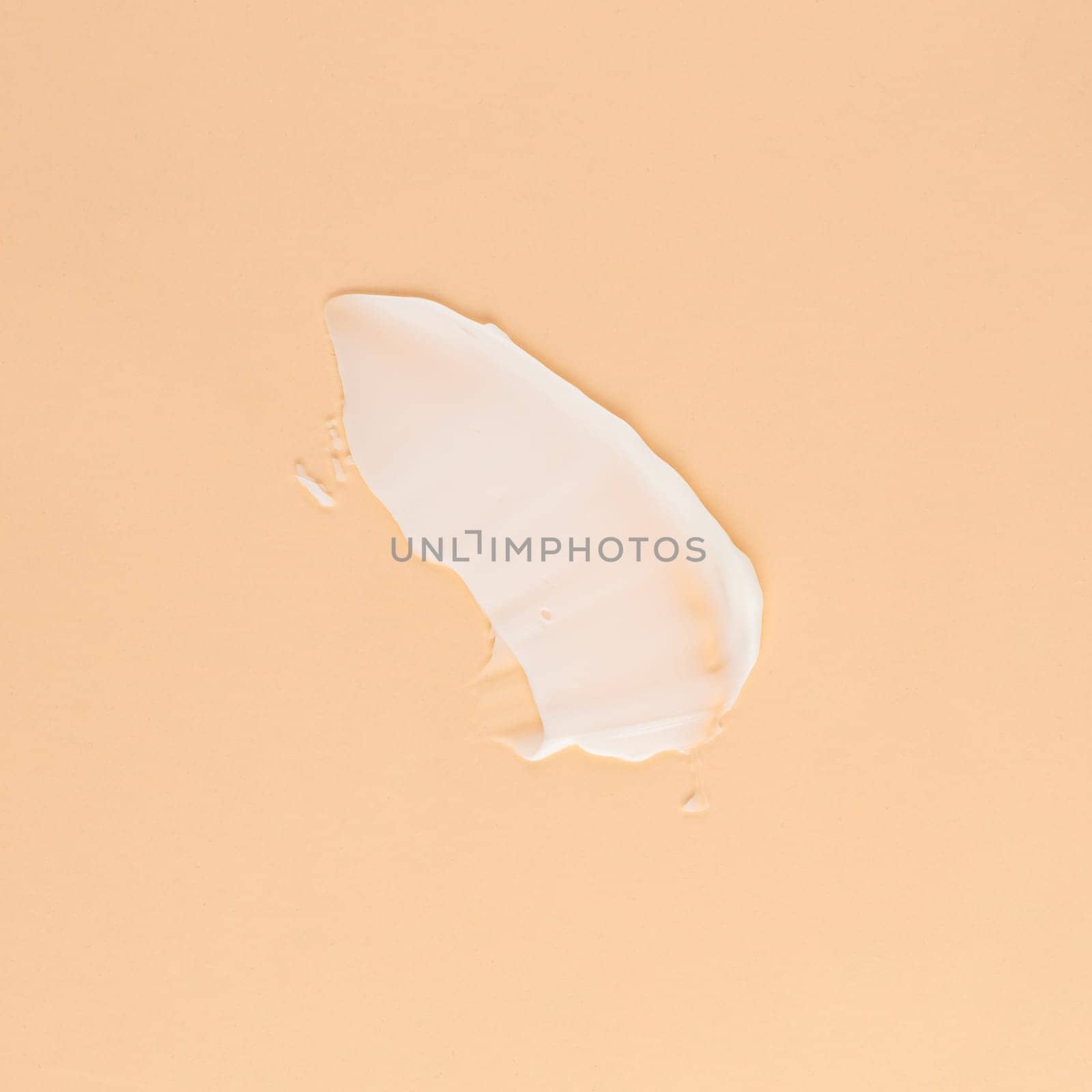 Smear of white cream for face and body on a brown background by A_Karim