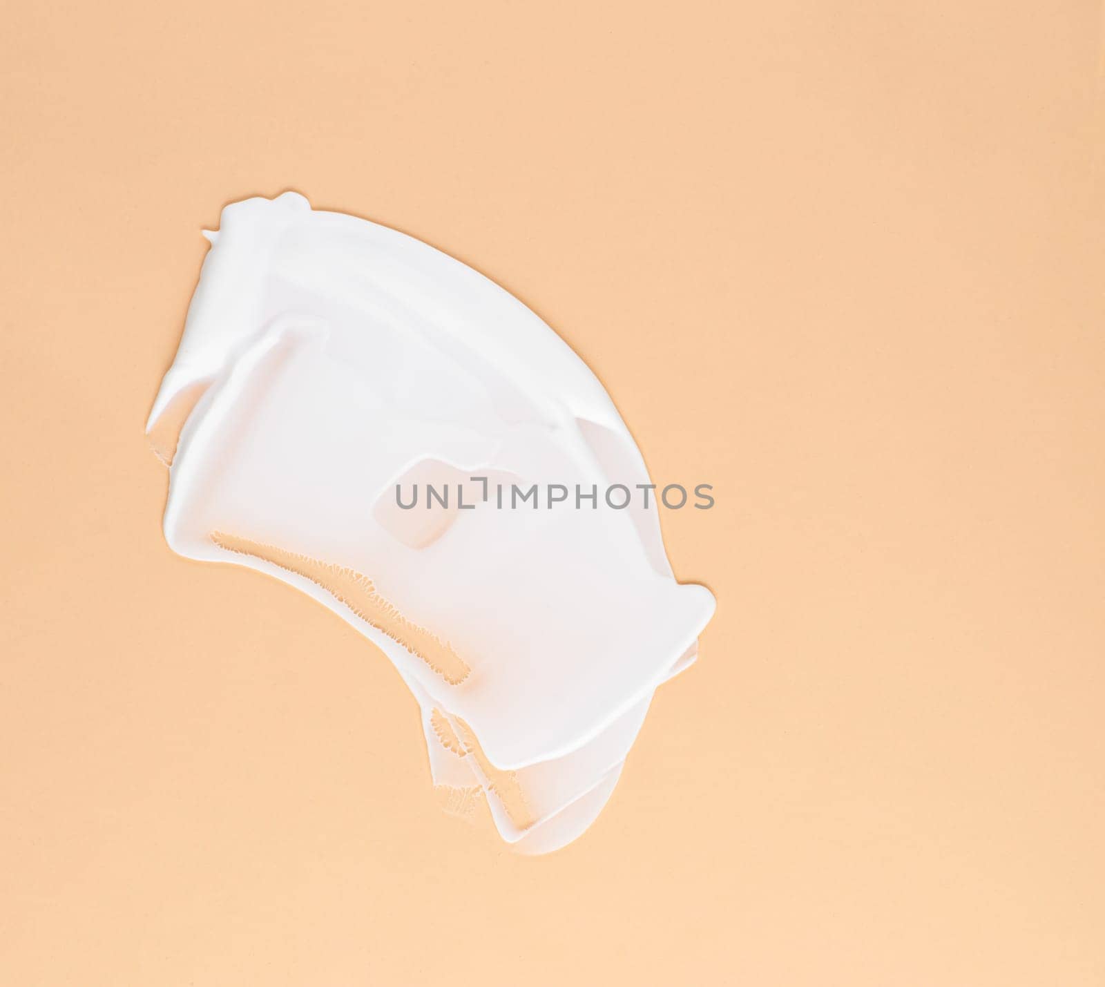 Smear of white cream for face and body on a brown background by A_Karim