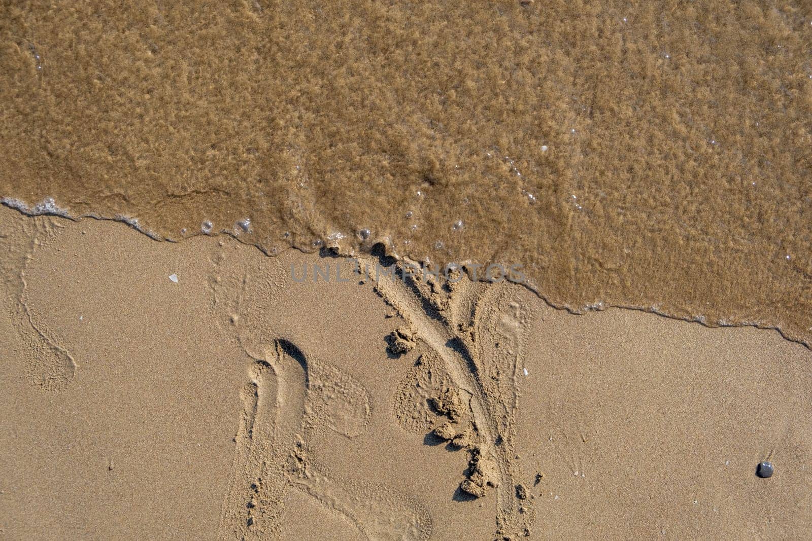 Heart shape and footprint on wet sand. by AnatoliiFoto
