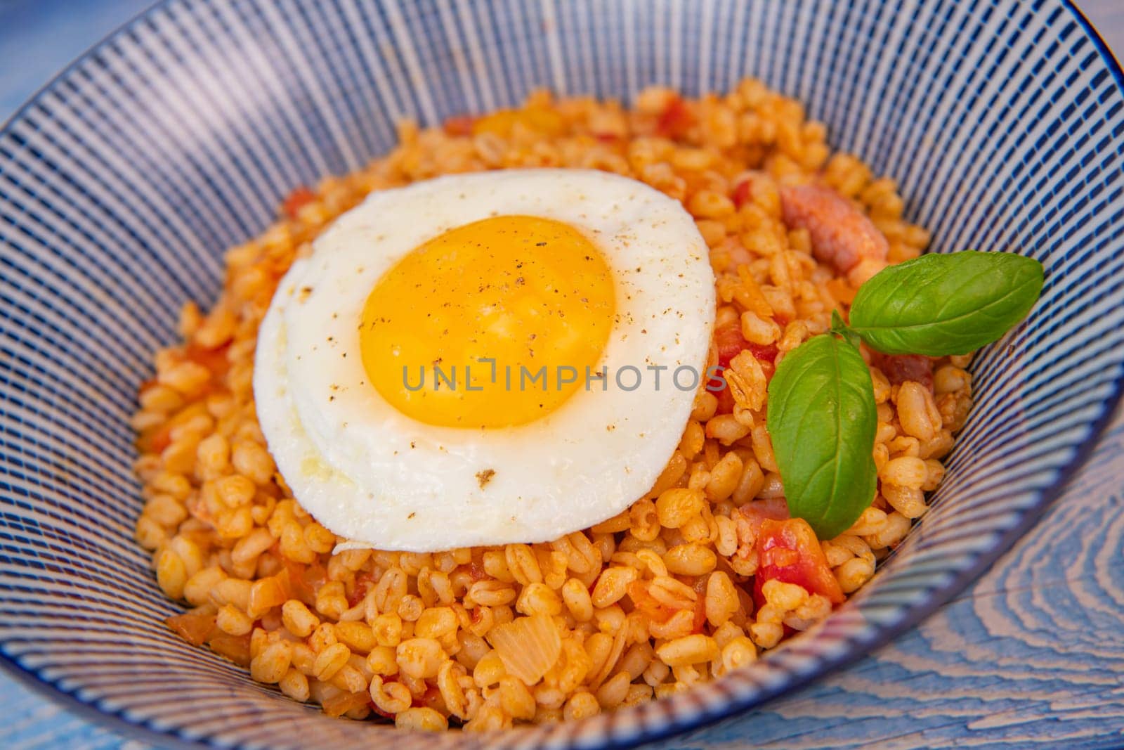 RECIPE FOR BLE WITH BACON, TOMATO AND SHALLOTS, SERVED WITH FRIED EGG. High quality photo