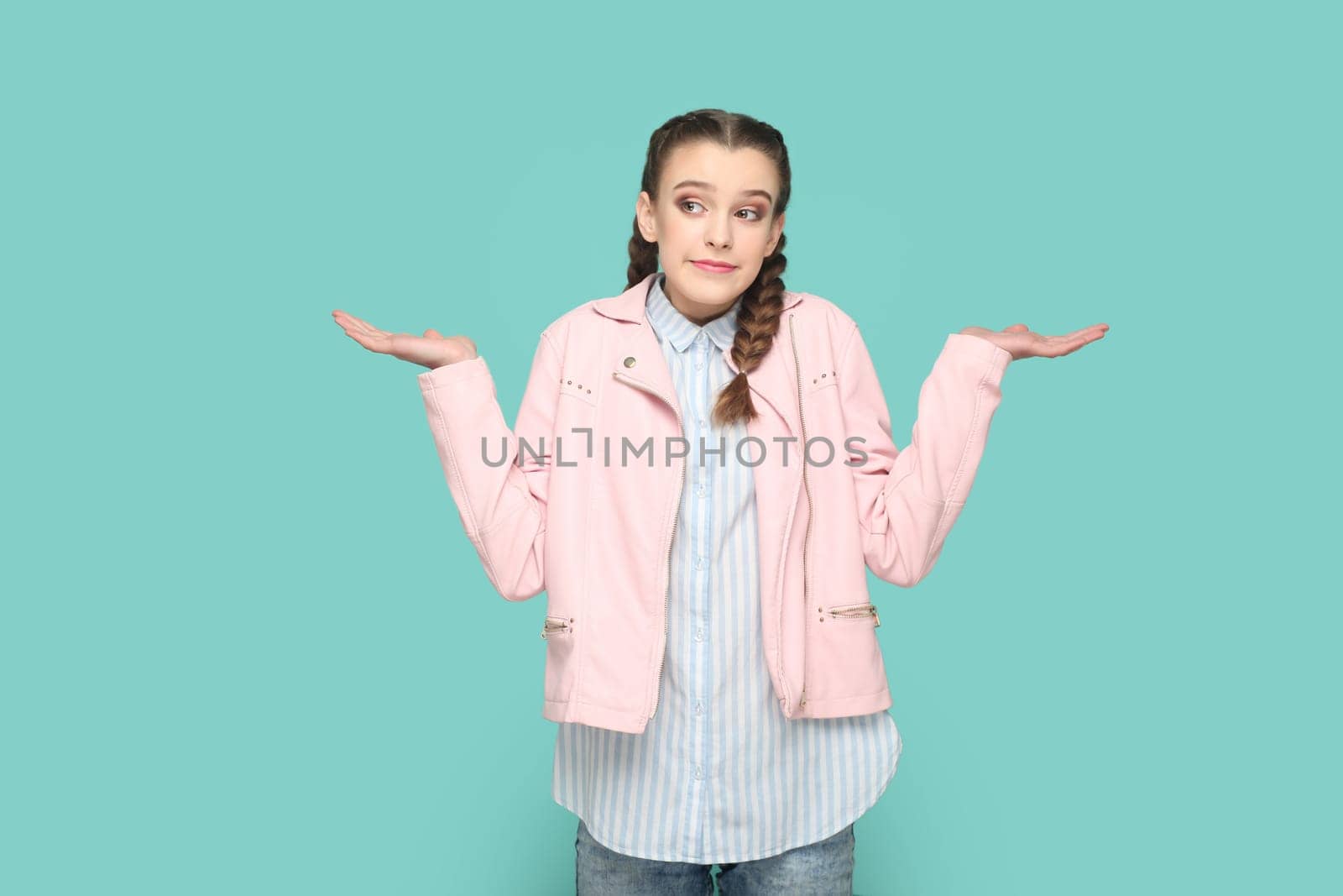 Uncertain confused teenager girl standing shrugging shoulders, spread hands, don't know answer. by Khosro1