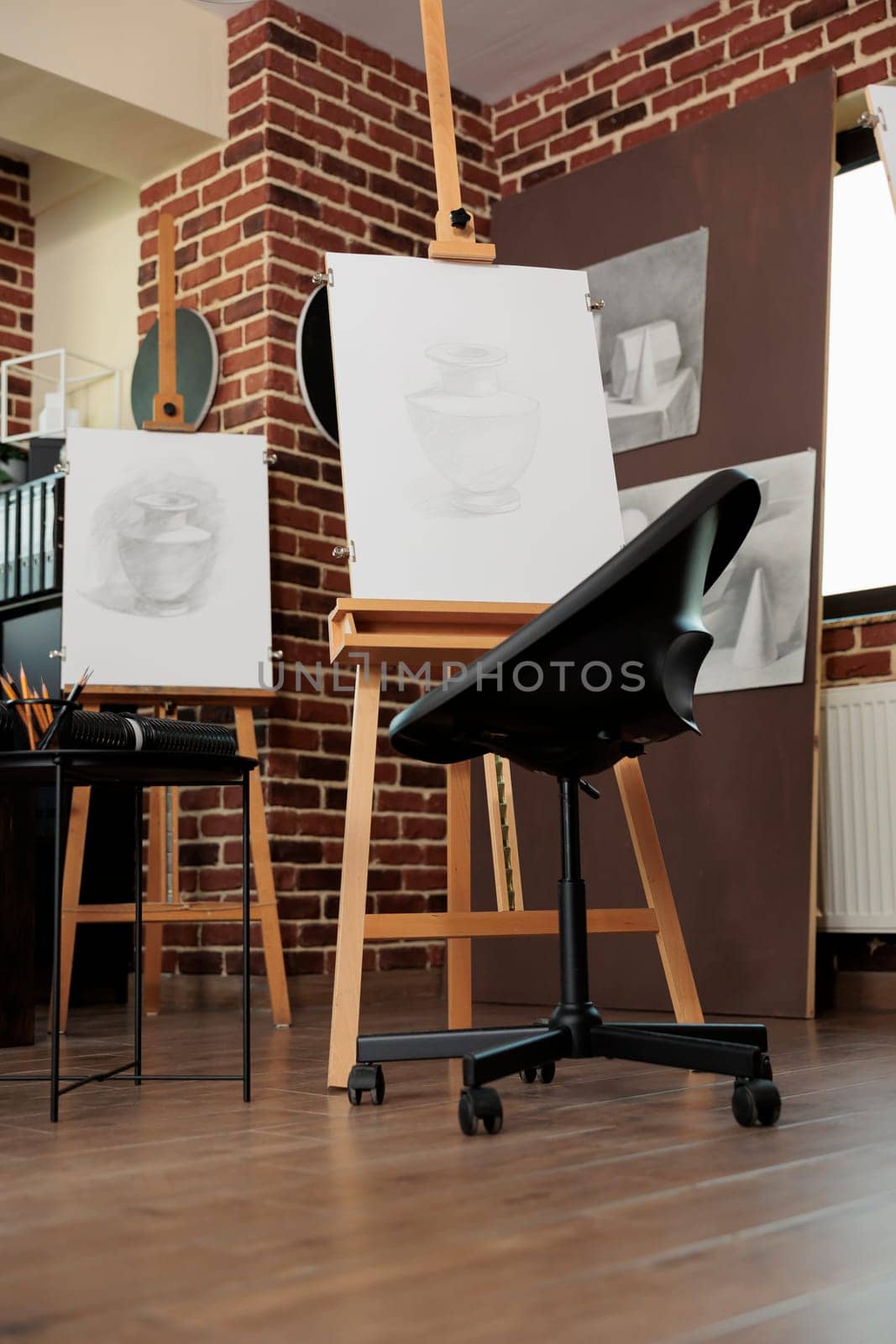 Art classroom interior with easels and drawing tools, nobody. Sketching classes and workshops in fine art for adults, sketch artworks in empty artist studio. Hobby to develop creativity