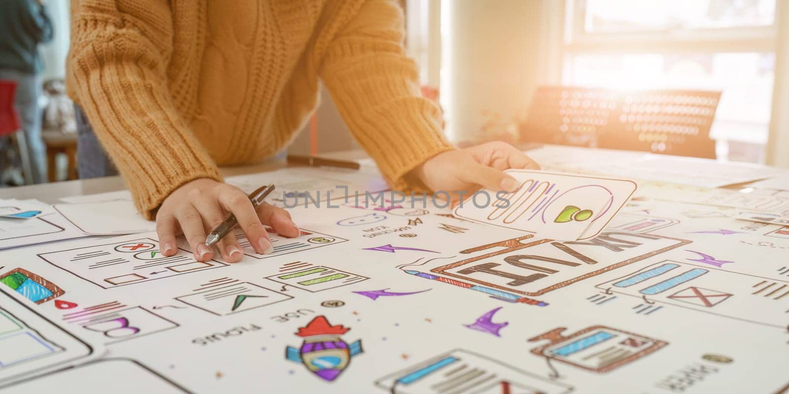 Close up of developer and ui designer brainstorming interface wireframe design.Creative digital development agency by itchaznong