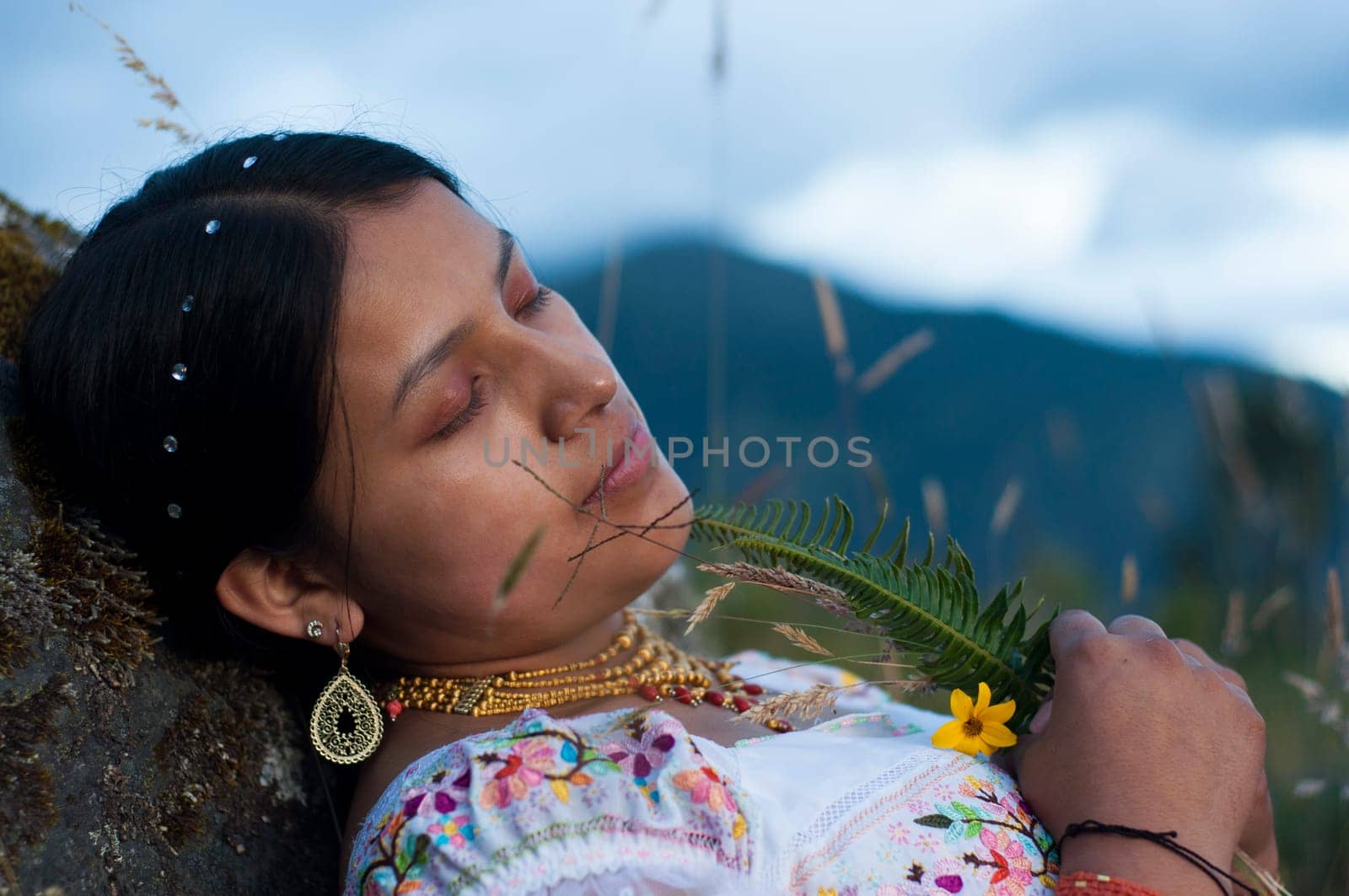 dead indigenous woman in her farewell ceremony in nature with some flowers in her hand. High quality photo