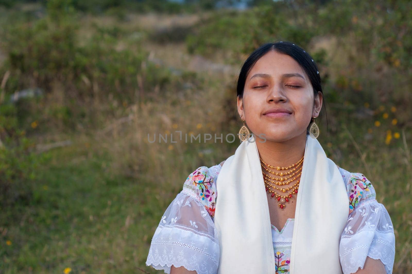 copyspace of beautiful young indian woman doing yoga and performing spiritual exercises in nature. High quality photo