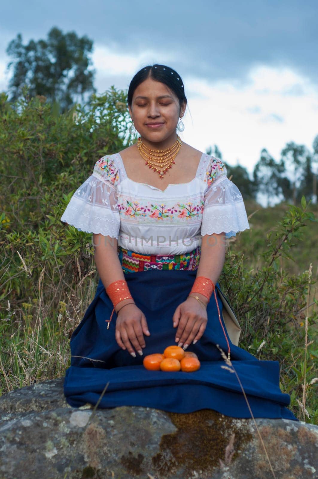 young indigenous woman in a traditional ceremony in nature with traditional clothing of her culture. High quality photo