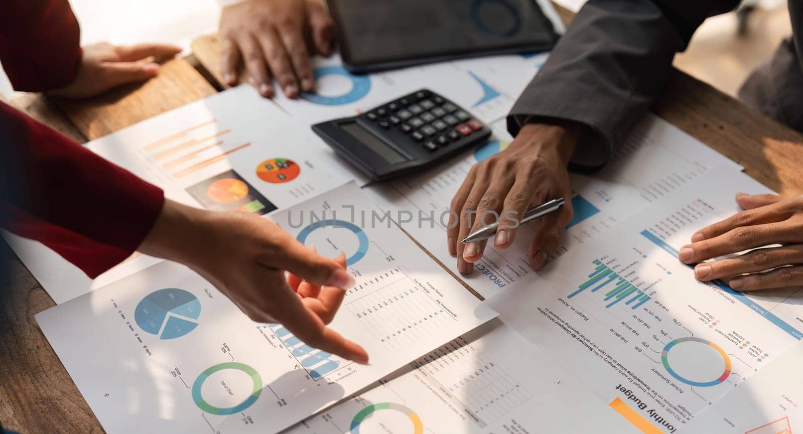 Business team analyzing income charts and graphs with modern laptop computer and digital tablet. Close up. Business analysis and strategy concept.