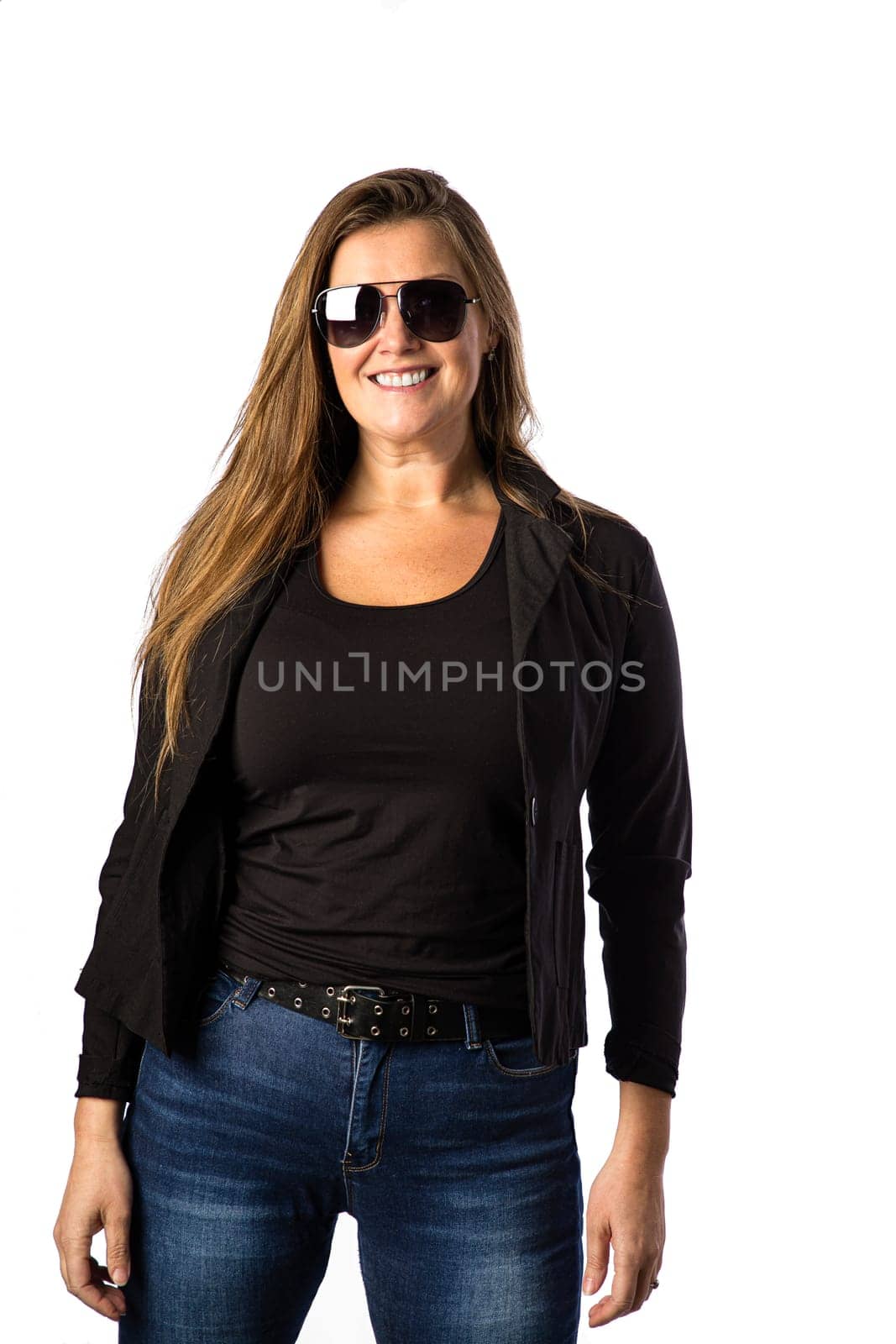 Forty year old woman, wearing sunglasses and a sport jacket, isolated on a white background