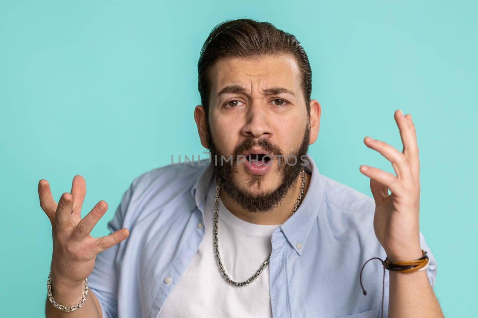 Oh my God, Wow. Excited amazed winner man surprise looking at camera with big eyes, shocked by sudden victory. Sincere confused shocked handsome lebanese guy isolated alone on blue studio background