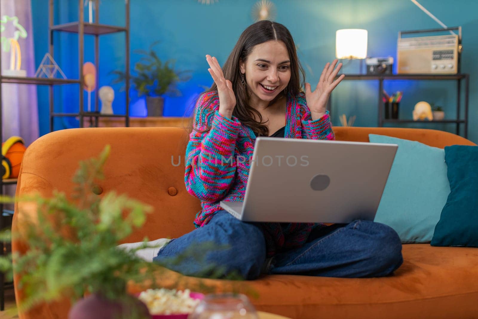 Surprised Caucasian woman using laptop computer, receive mail good news message, shocked by sudden victory celebrate lottery jackpot win purchases online shopping at home apartment on sofa. Lifestyles