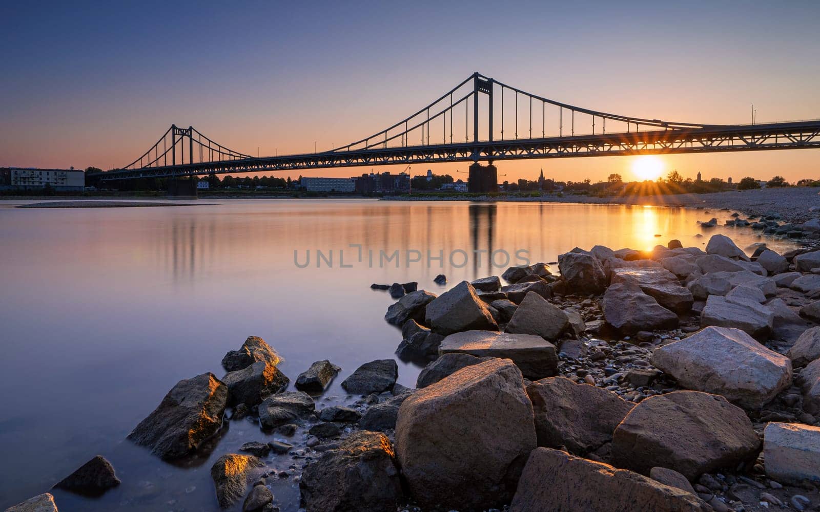 Old bridge crossing the Rhine river during sunset, Krefeld, North Rhine Westphalia, Germany