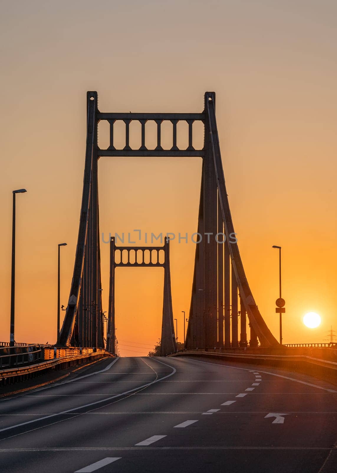 Old bridge crossing the Rhine river during sunrise, Krefeld, North Rhine Westphalia, Germany