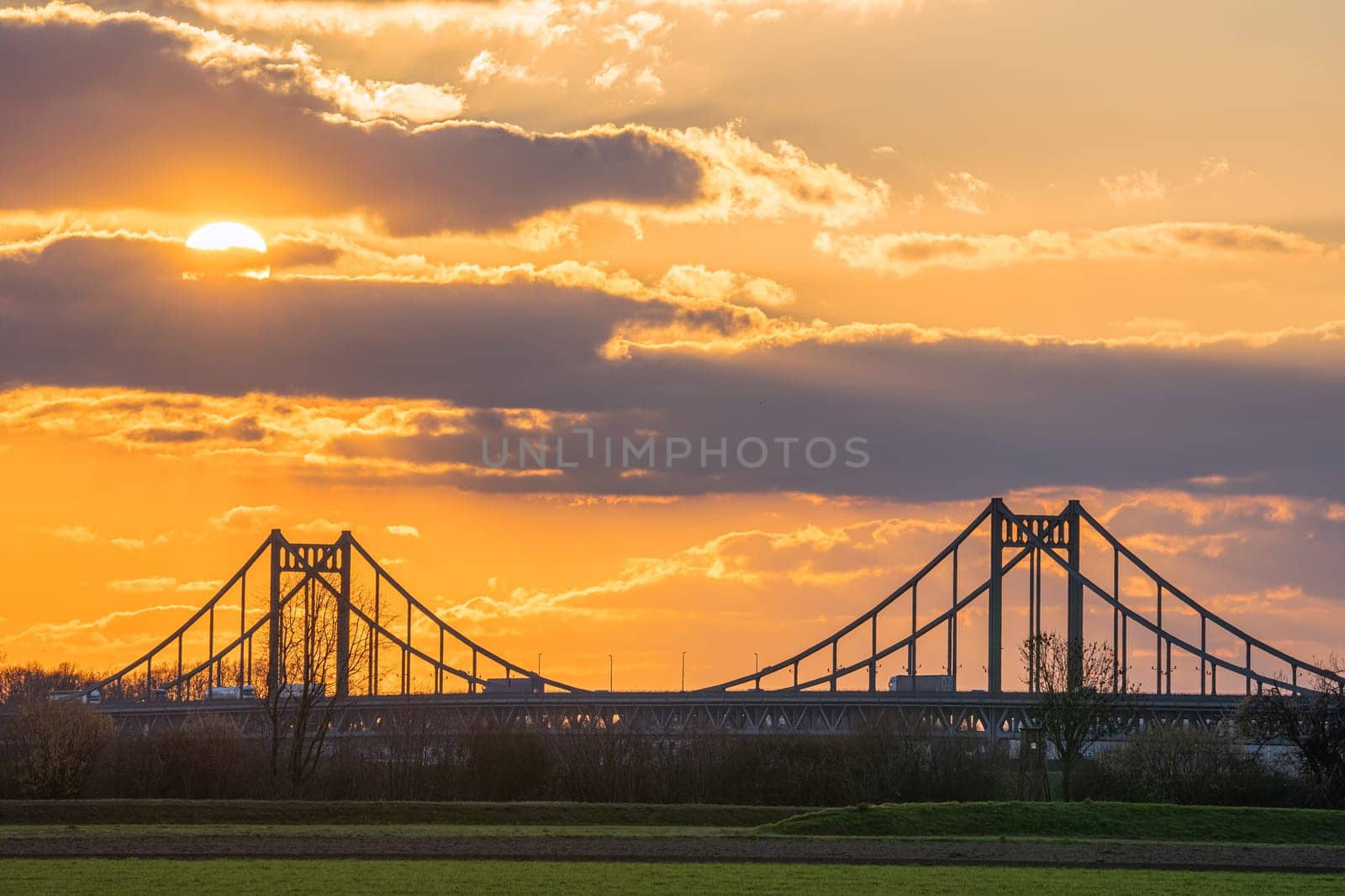 Old bridge crossing the Rhine river during sunset, Krefeld, North Rhine Westphalia, Germany