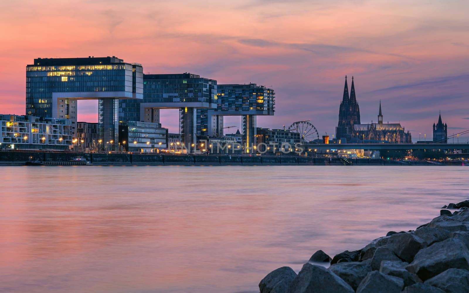 COLOGNE, GERMANY - JUNE 23, 2023: Panoramic image of modern buildings in the harbor of Cologne during sunset on June 23, 2023 in Germany, Europe