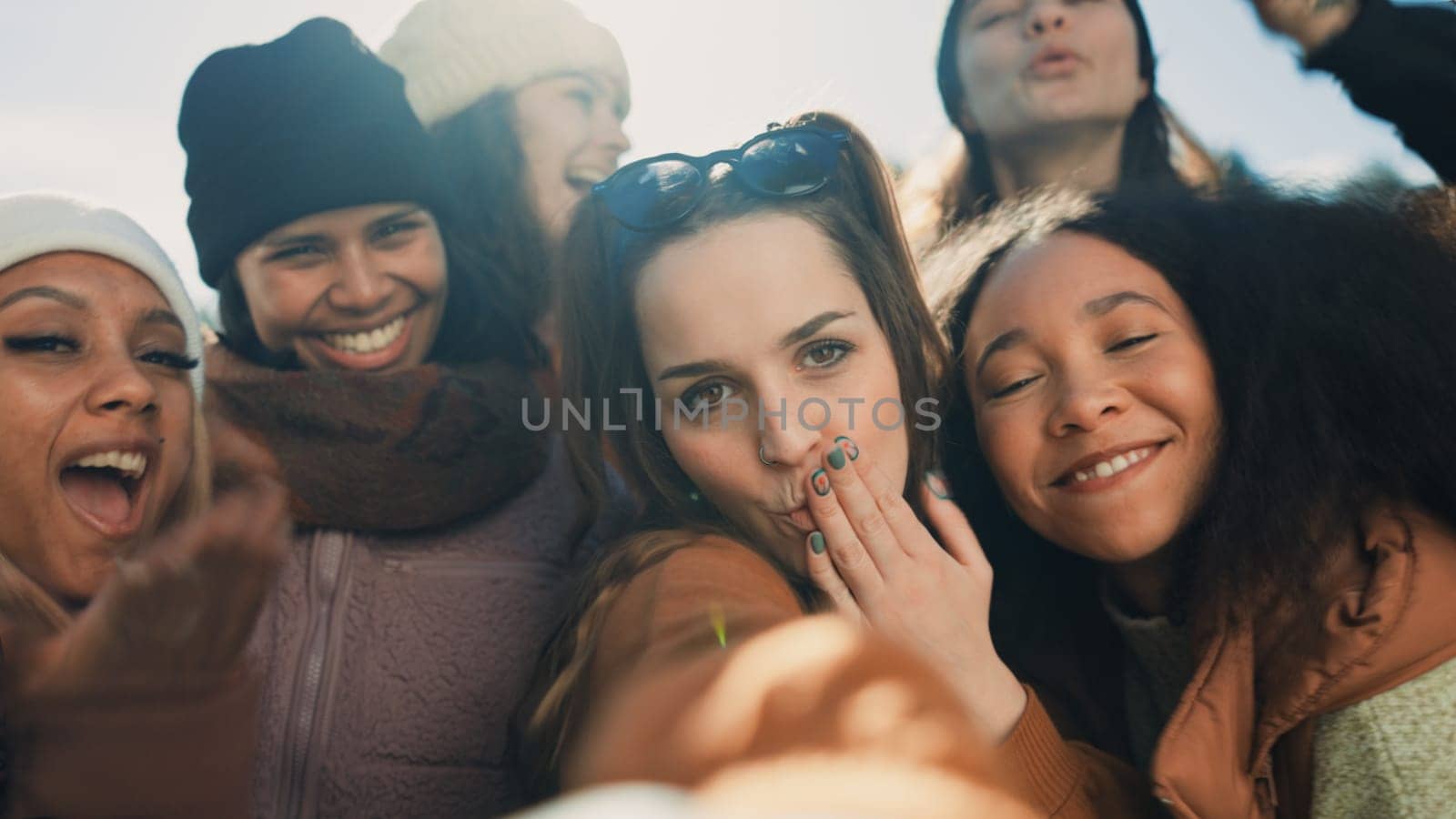 Selfie, group of happy friends and camping adventure, hugging together with diversity and friendship. Smile on face, photography and women on nature camp to relax, laugh and outdoor winter vacation. by YuriArcurs