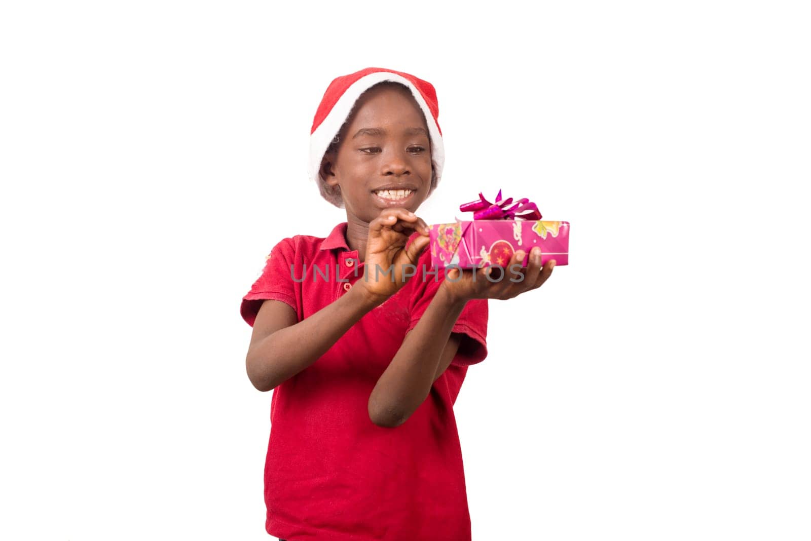 Unpack the Christmas present. Happy childhood concept. Holiday and party tradition. Kid with a Christmas present in hand.