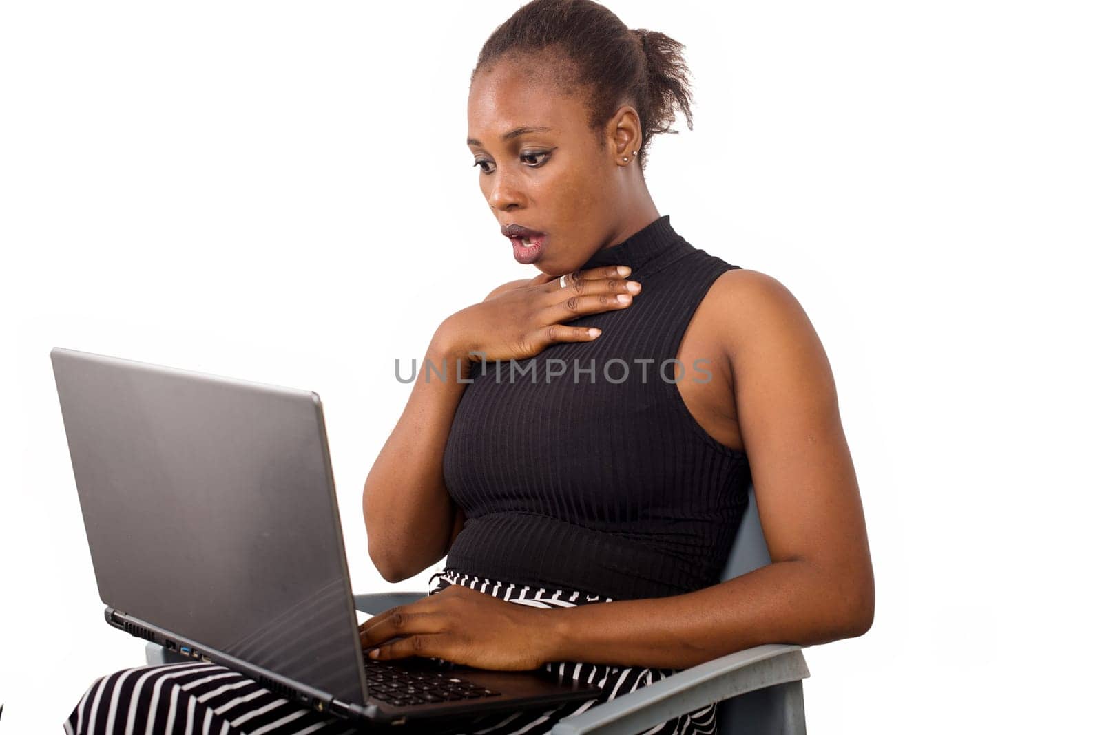 surprised business woman looks on laptop. Charming beautiful woman holding a laptop and looking for some business information.